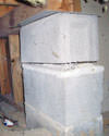 Concrete crawl space support posts in Booneville that are showing signs of failure as they sink into the earth.