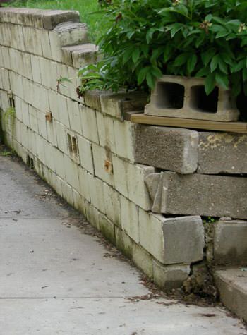 collapsing retaining wall with severe damage in Hernando