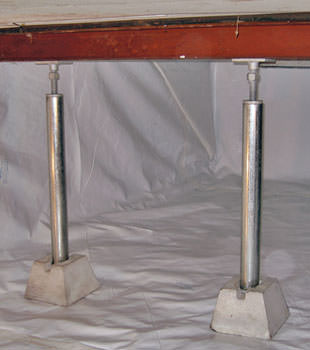 Crawl space jack posts installed in conjunction with a crawl space vapor barrier in Byhalia