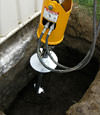 Installing a helical pier during a foundation repair in Tupelo