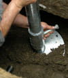 Tupelo helical pier installation nearing completion, with the blade being advanced into the foundation soils.