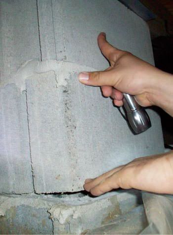 a completely failing concrete crawl space support pillar in Brownsville