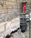 A completed installation of foundation push piers lifting a foundation in Forrest City