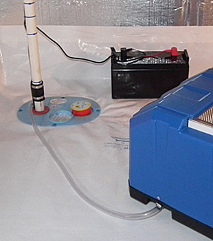 Closeup of a crawl space sump pump installed in Oxford