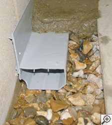 A no-clog basement french drain system installed in Oxford