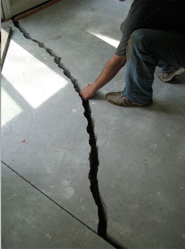 a severely damaged cracked concrete slab floor in Tupelo