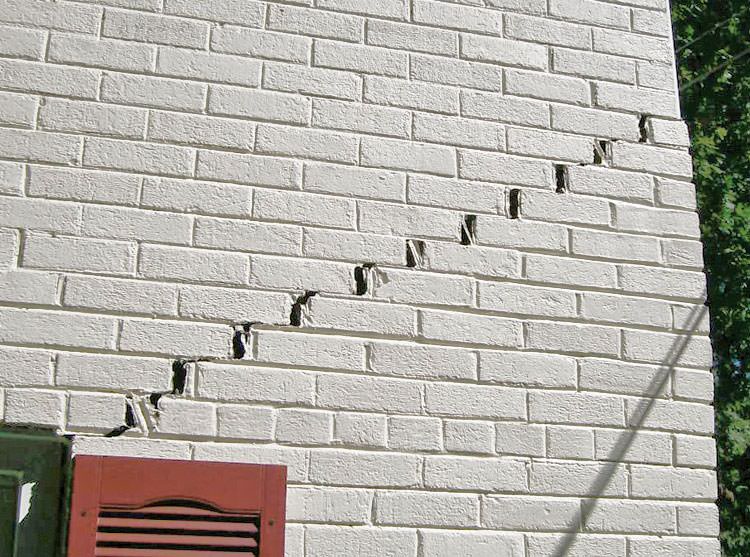 Stair-step cracks showing in a home foundation in Millington