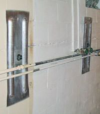 A foundation wall anchor system used to repair a basement wall in Pine Bluff