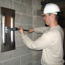 installing a wall anchor to repair an bowing foundation wall in Germantown