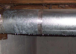 condensation collecting on an HVAC vent in a humid Hot Springs basement